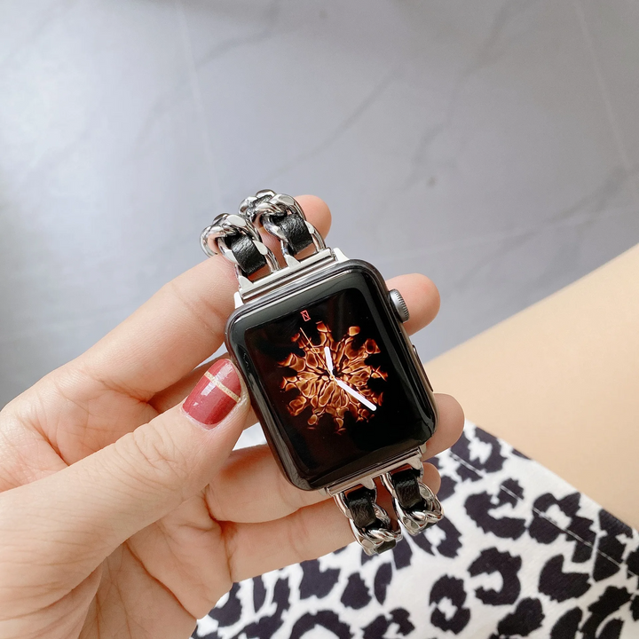 Silver elegant chain link Apple Watch band for women, polished fashion accessory. Chic metal smartwatch strap.