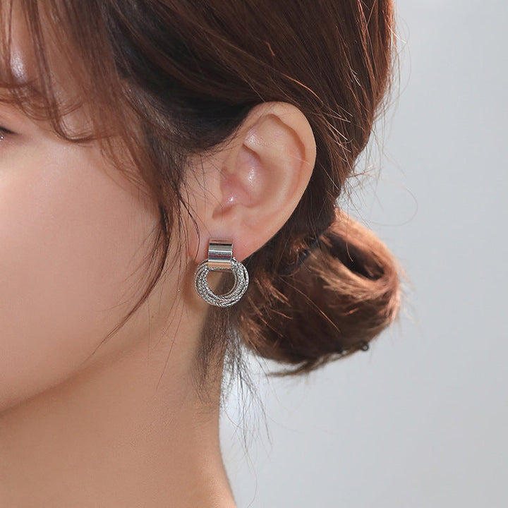 Sleek silver-tone circle stud earrings. Elegant women's jewelry, minimalist, versatile, timeless accessory.