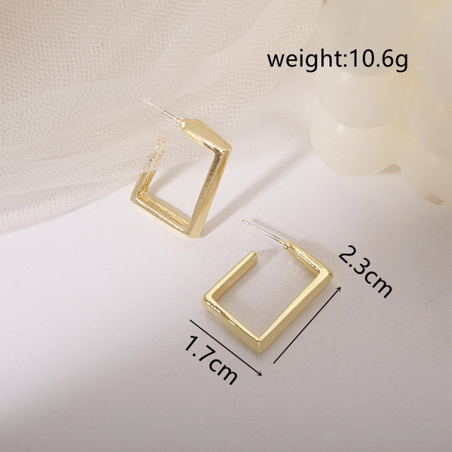 Polished silver-tone circle stud earrings. Elegant women's studs, minimalist design for versatile style.