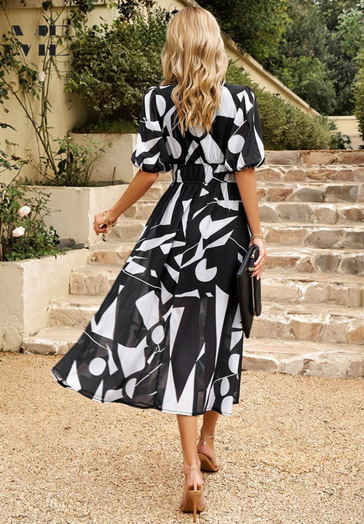 Flowy A-line floral midi dress with puff sleeves and elastic waist for a comfortable, elegant fit.