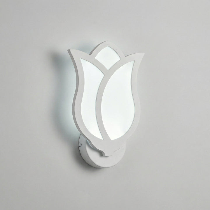 Florique wall mounted floral sconce glowing with warm LED light, creating a cozy and inviting atmosphere indoors.