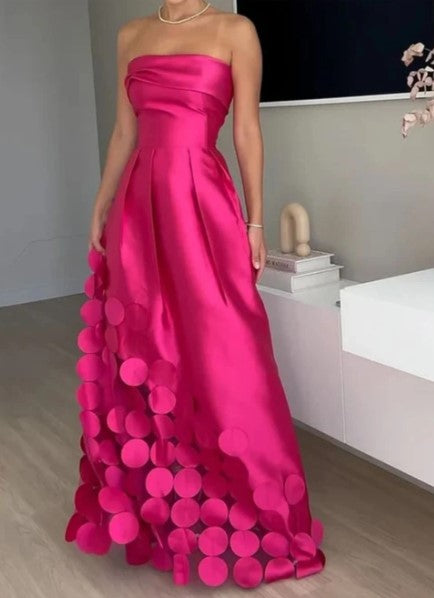 Elegant fuchsia strapless maxi dress for women, perfect as a wedding guest or formal evening gown with a petal hem.