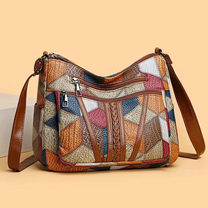 Women's geometric crossbody bag, a chic vegan leather accessory for modern fashion.