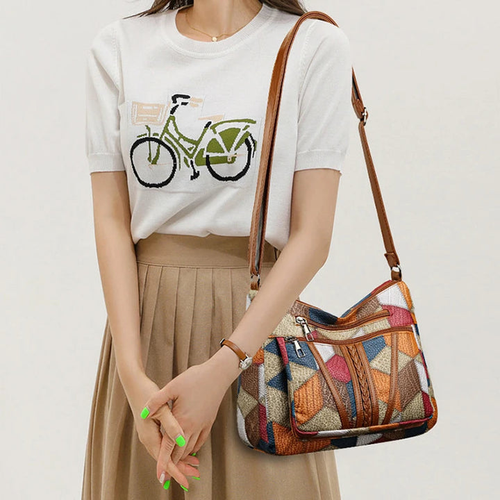 High-quality vegan leather women's handbag with an elegant geometric and patchwork design.