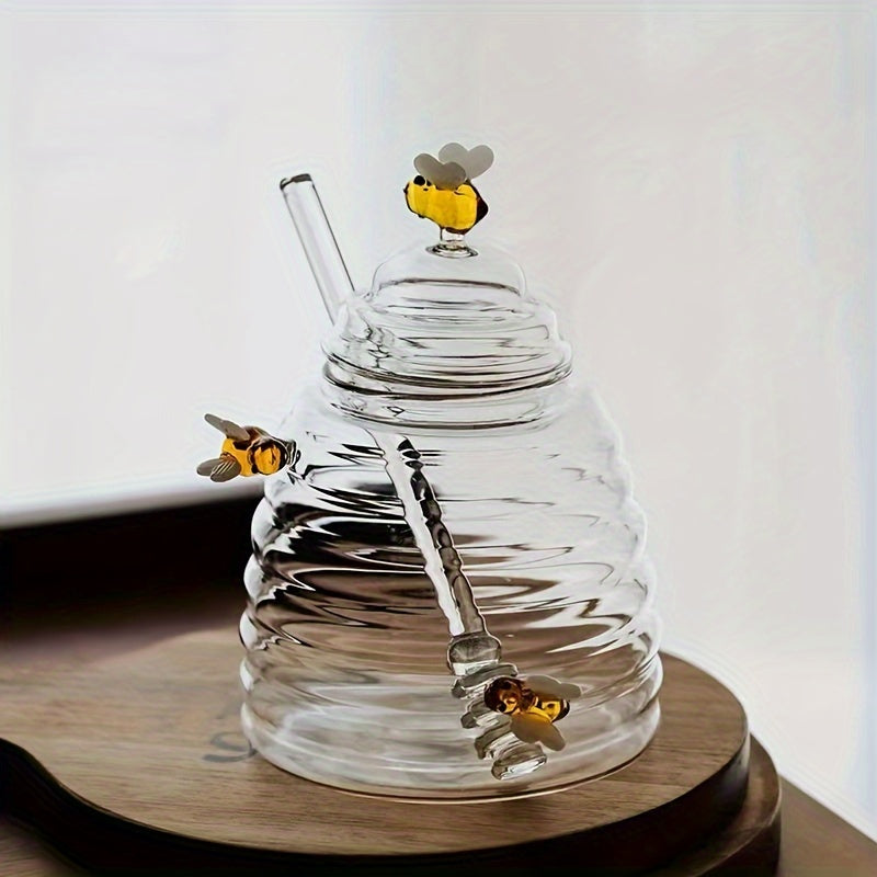 Borosilicate glass honey jar with dipper, elegant beehive design, ideal for serving honey or syrup.