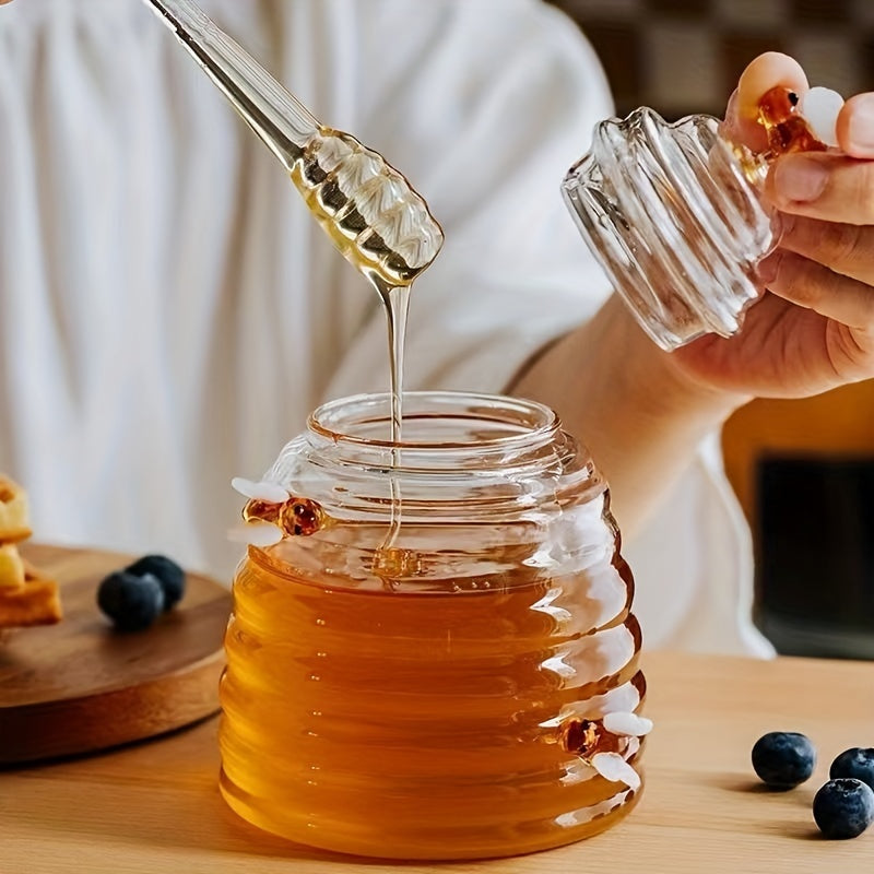 Beautiful beehive glass honey pot with included dipper. A stylish addition to any kitchen or table.