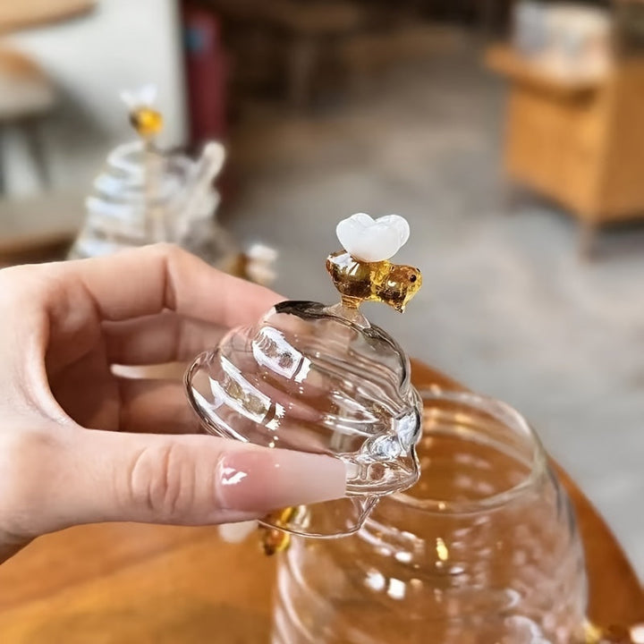Kitchen decor: Beehive design glass honey jar with dipper, made from durable borosilicate glass.