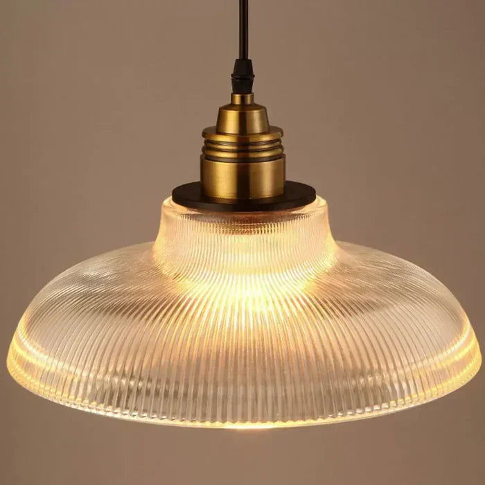 Stylish glass pendant light fixture above a dining table. Elegant ceiling lamp, enhancing dining room decor.