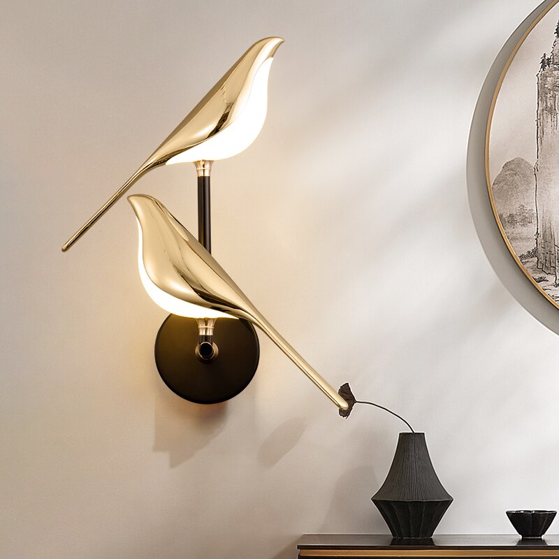 Modern gold bird wall sconce with LED light, ideal for contemporary bedroom or hallway accent lighting.