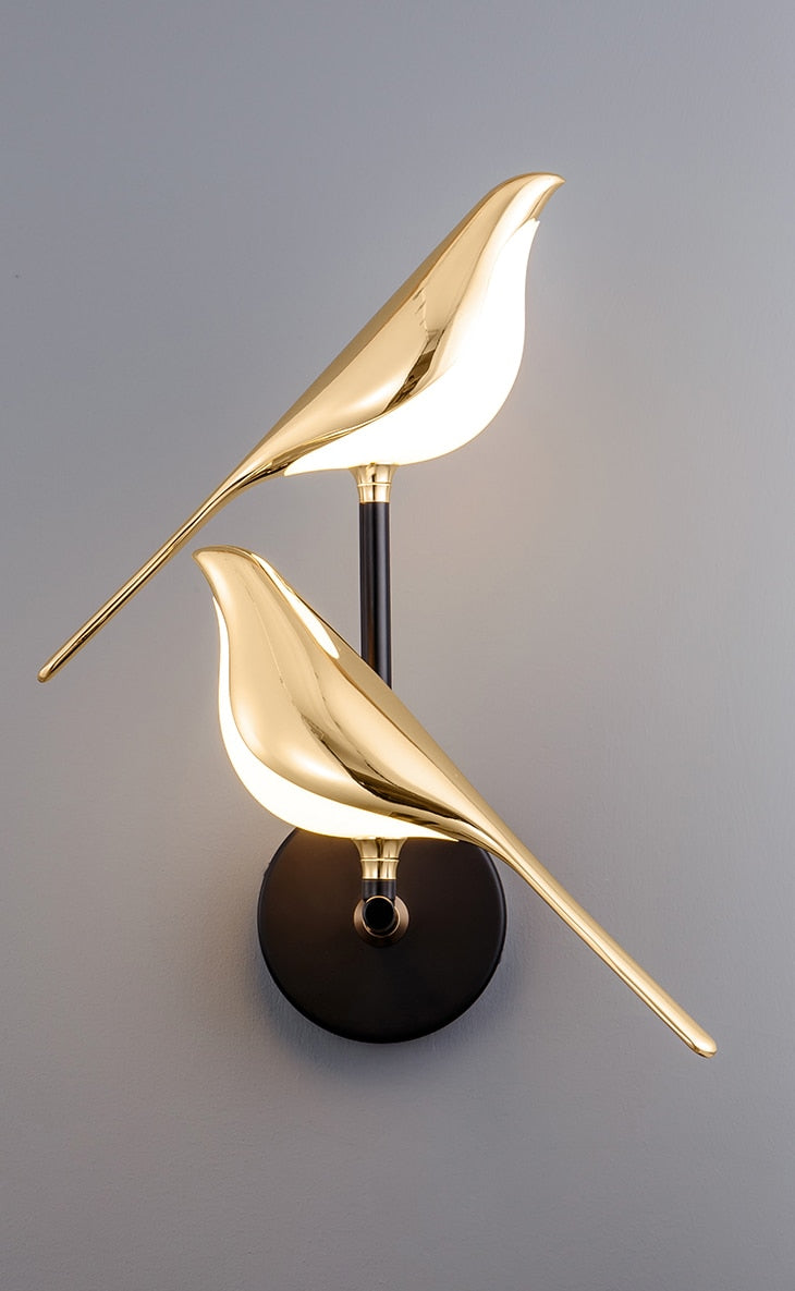 Elegant bird design LED wall lamp, a stunning gold fixture providing ambient light & modern home decor.