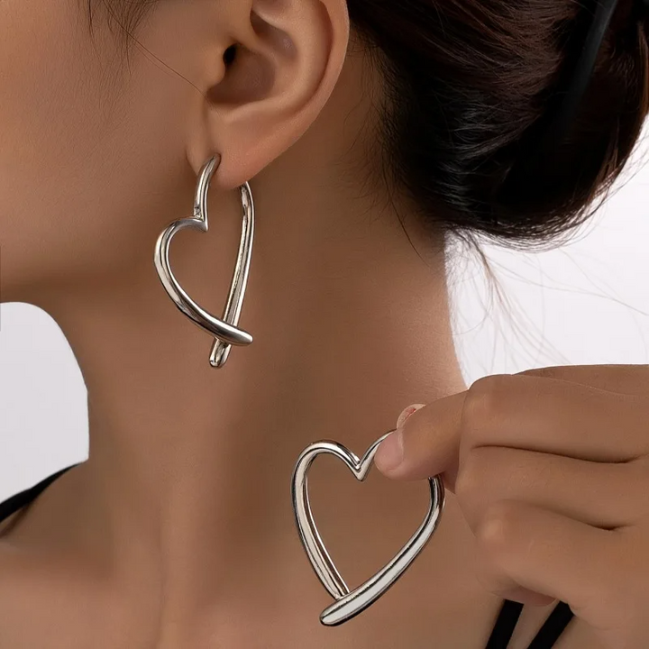 Close-up of elegant women's gold heart hoop earrings, featuring a sleek non-tarnish design.