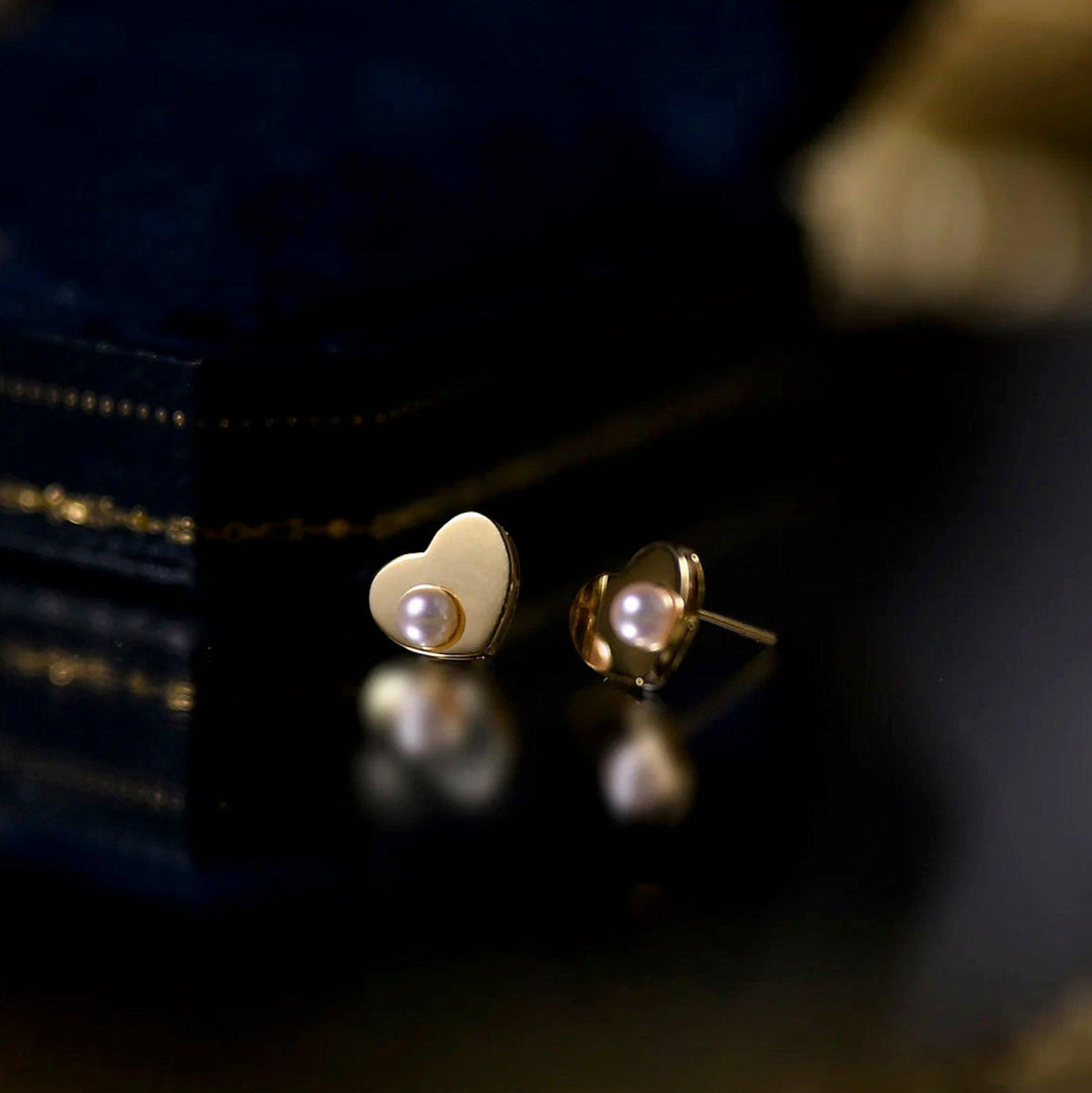 Stylish women's gold heart stud earrings featuring lustrous pearls, a thoughtful gift