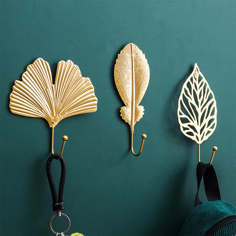 Heavy-duty gold leaf cast iron wall hook, a decorative and functional accessory for robes, bags, or coats.