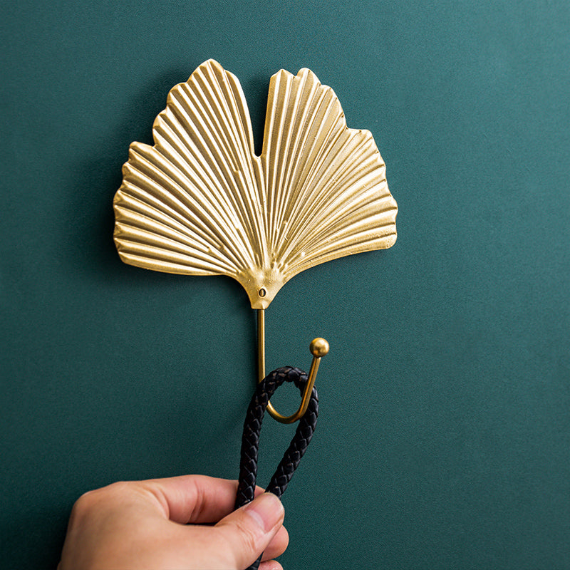 Intricate gold leaf cast iron wall hook, a durable and beautiful home decor addition for entryway or bedroom.