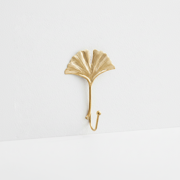 Luxurious gold leaf cast iron wall hook, offering a decorative storage solution for coats, towels, or keys.