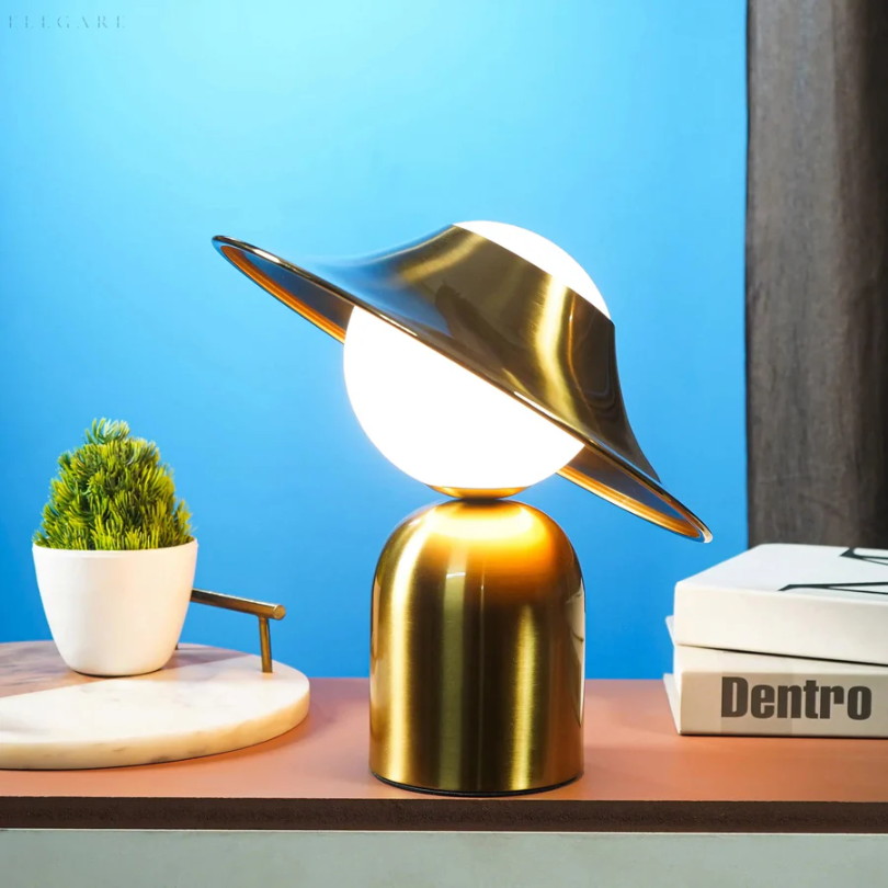 Modern gold metal table lamp providing warm home lighting, an elegant accent for any bedroom or living room.