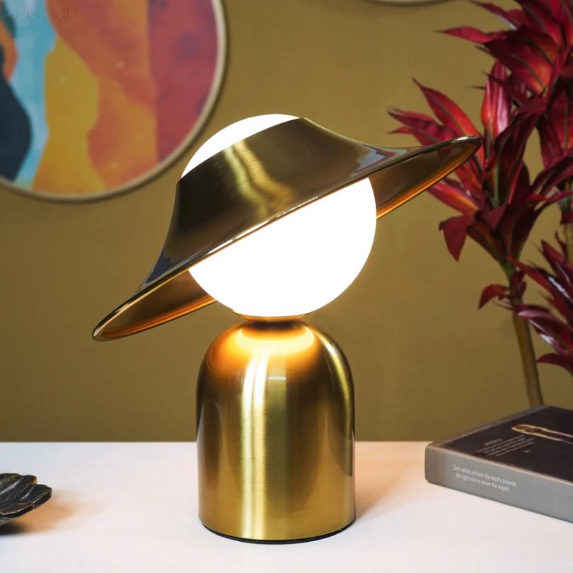 Stylish GoldAura table lamp, a luxurious metal accent light for contemporary bedroom decor or living room ambiance.