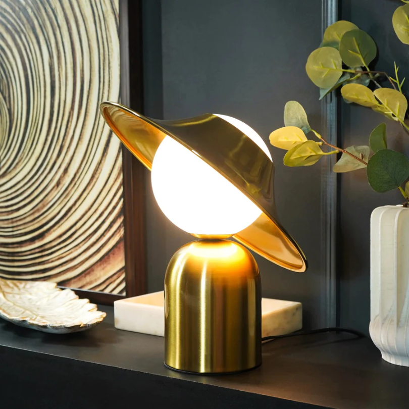 Chic gold metal table lamp, enhancing modern home decor with its elegant design and sophisticated lighting.