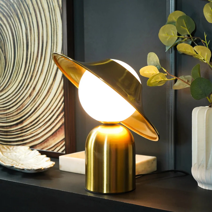 Chic gold metal table lamp, enhancing modern home decor with its elegant design and sophisticated lighting.