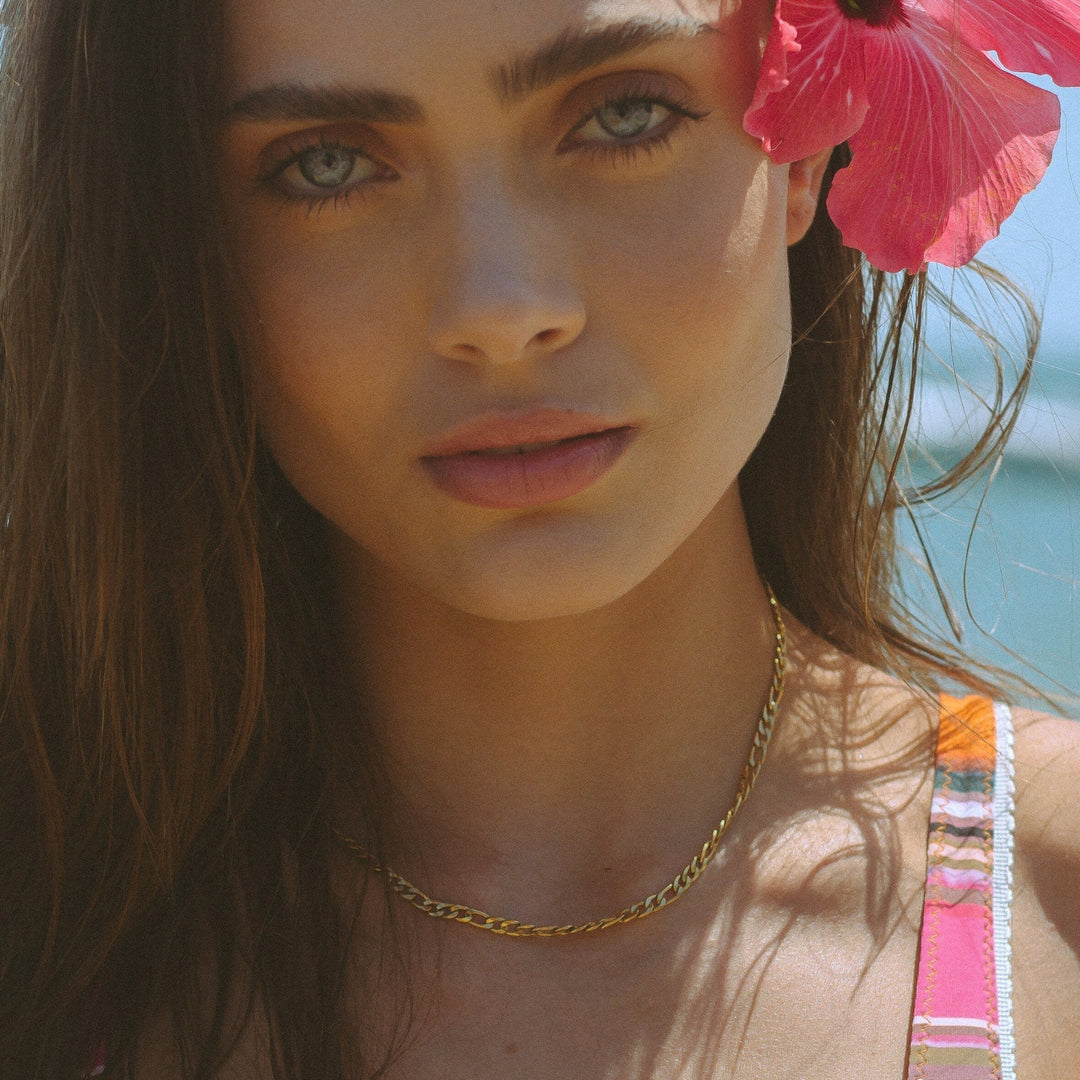 Close-up of a delicate gold minimalist choker necklace, a chic women's jewelry accessory for elegant style.