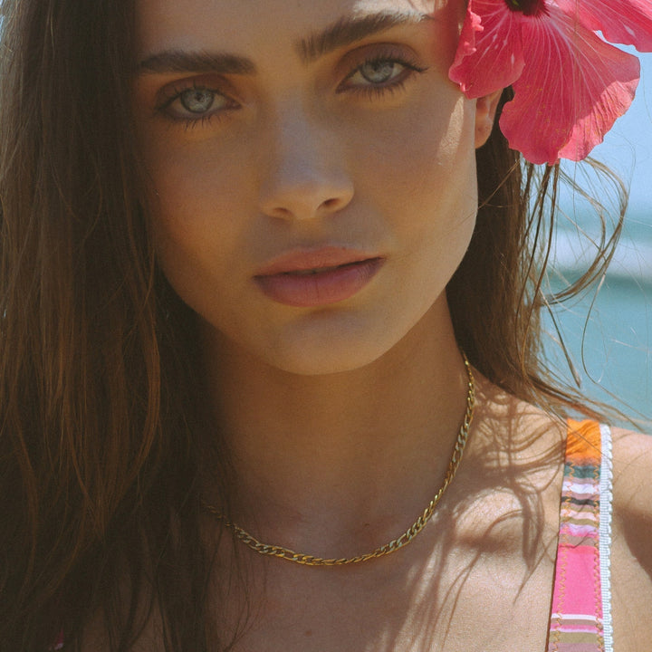 Close-up of a delicate gold minimalist choker necklace, a chic women's jewelry accessory for elegant style.