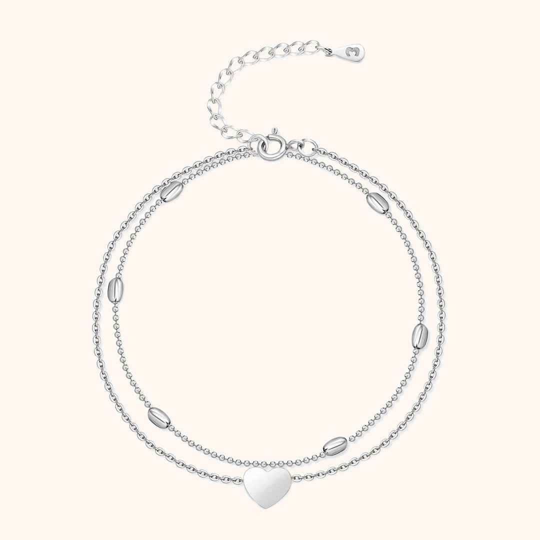 Stylish women's gold-plated sterling silver heart charm anklet, featuring a chic double chain design.