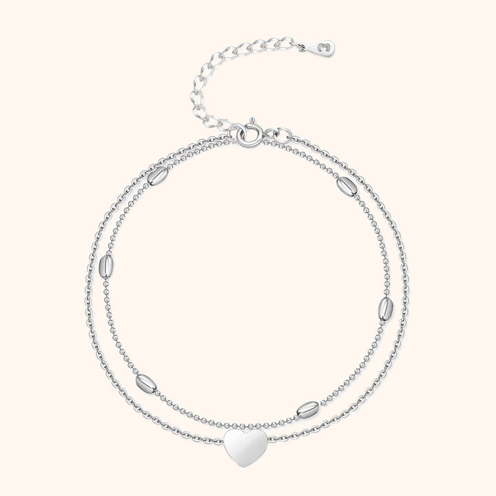 Stylish women's gold-plated sterling silver heart charm anklet, featuring a chic double chain design.