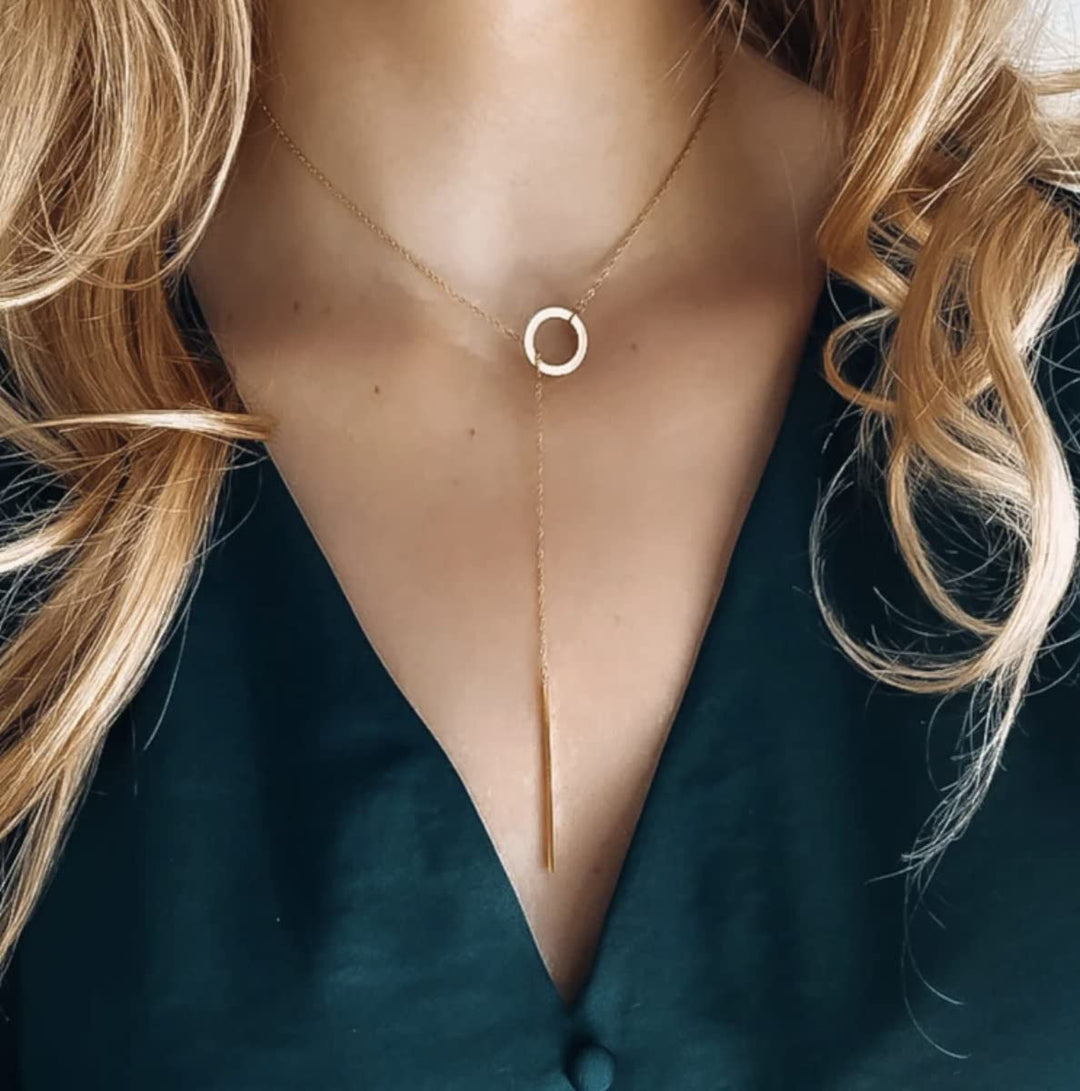 Minimalist gold plated drop bar lariat necklace. Elegant and dainty women's fashion jewelry.