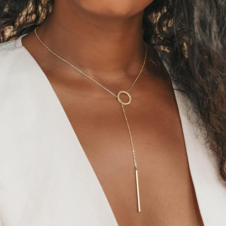 Gold drop bar lariat necklace for women. Elegant, versatile, and dainty gold plated jewelry.
