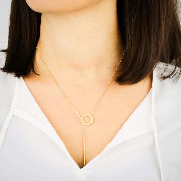 Chic gold drop bar lariat necklace for women. Modern, elegant, and versatile fashion accessory.