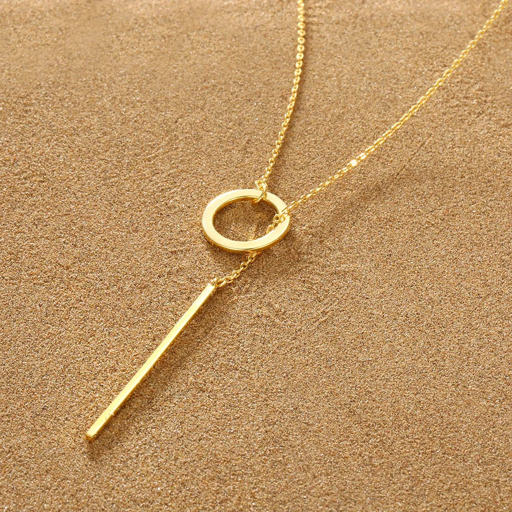 Gold plated adjustable lariat necklace with a sleek drop bar. Elegant women's fashion accessory.