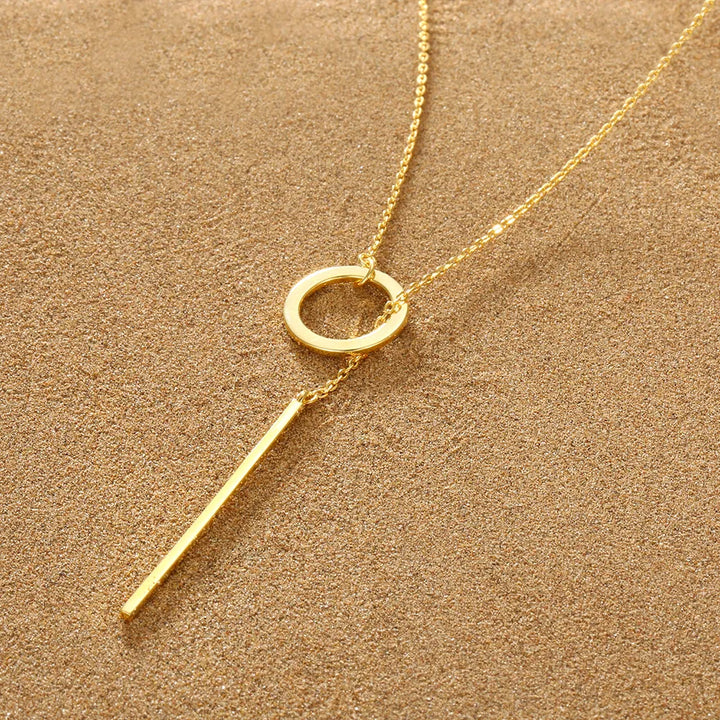 Gold plated adjustable lariat necklace with a sleek drop bar. Elegant women's fashion accessory.