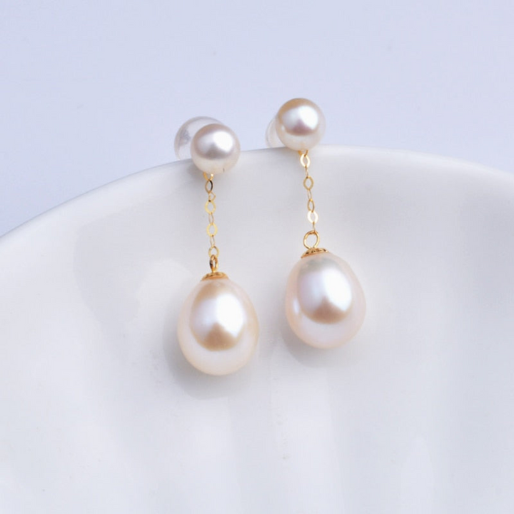 Elegant gold-plated drop earrings with lustrous pearls, a classic fine jewelry accessory for women.