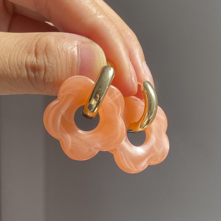 Fashionable gold plated flower earrings for women, featuring a beautiful dangling flower.