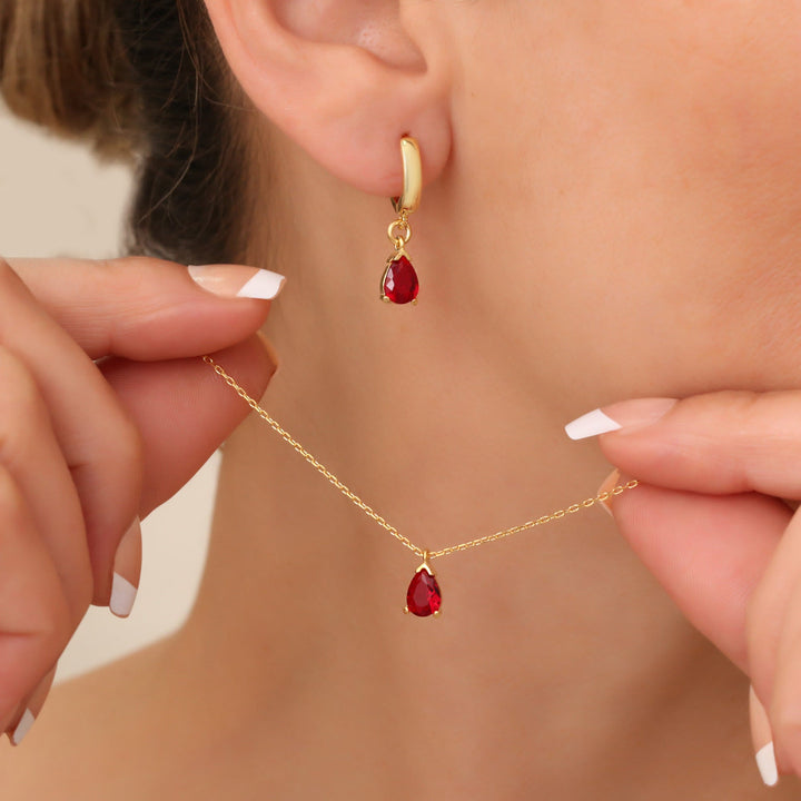 Elegant gold plated garnet birthstone jewelry set with teardrop necklace & matching earrings for women.