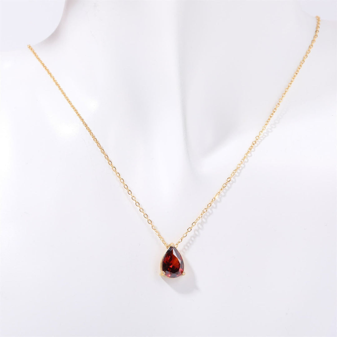 Gold plated women's necklace with a teardrop garnet pendant & delicate matching stud earrings.