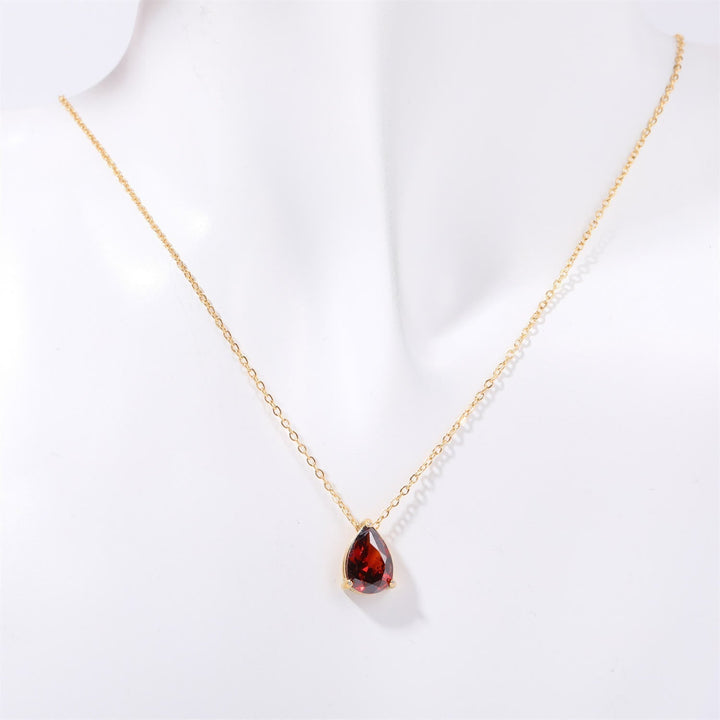 Gold plated women's necklace with a teardrop garnet pendant & delicate matching stud earrings.