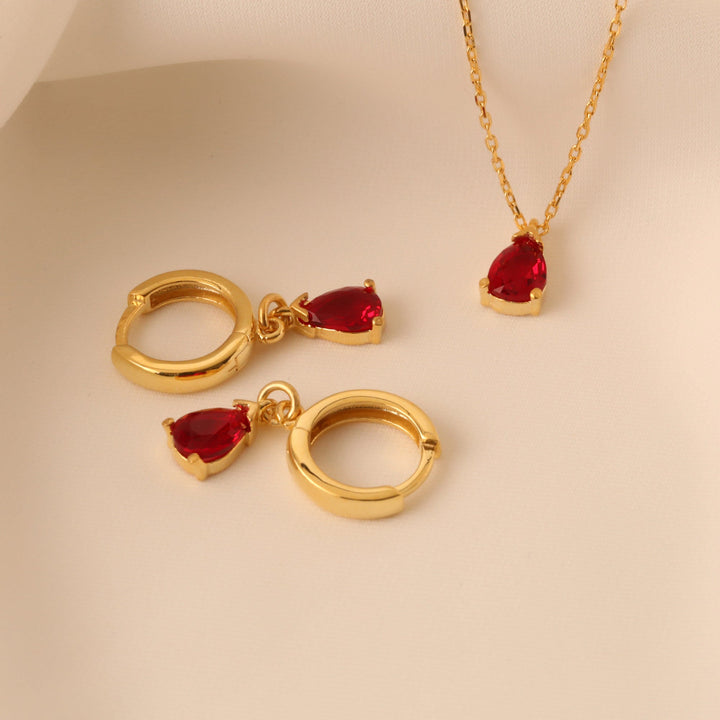 Dazzling red garnet birthstone jewelry set, gold plated with elegant teardrop pendant & earrings for women.