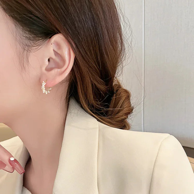 Women's elegant pearl hoop earrings. Gold-plated, classic and subtle design. Perfect for everyday wear or a special gift.