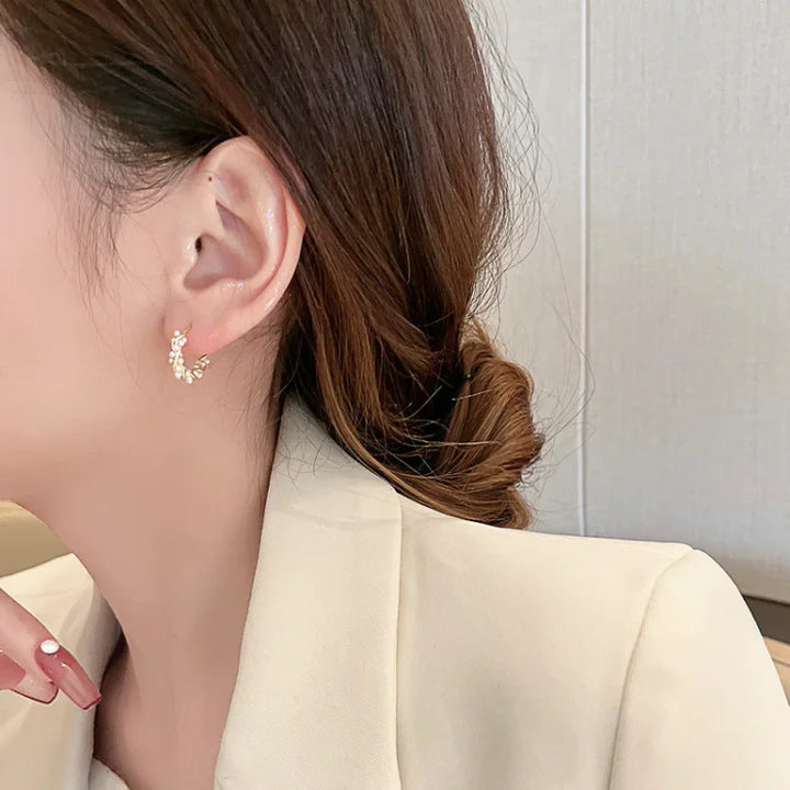 Women's elegant pearl hoop earrings. Gold-plated, classic and subtle design. Perfect for everyday wear or a special gift.