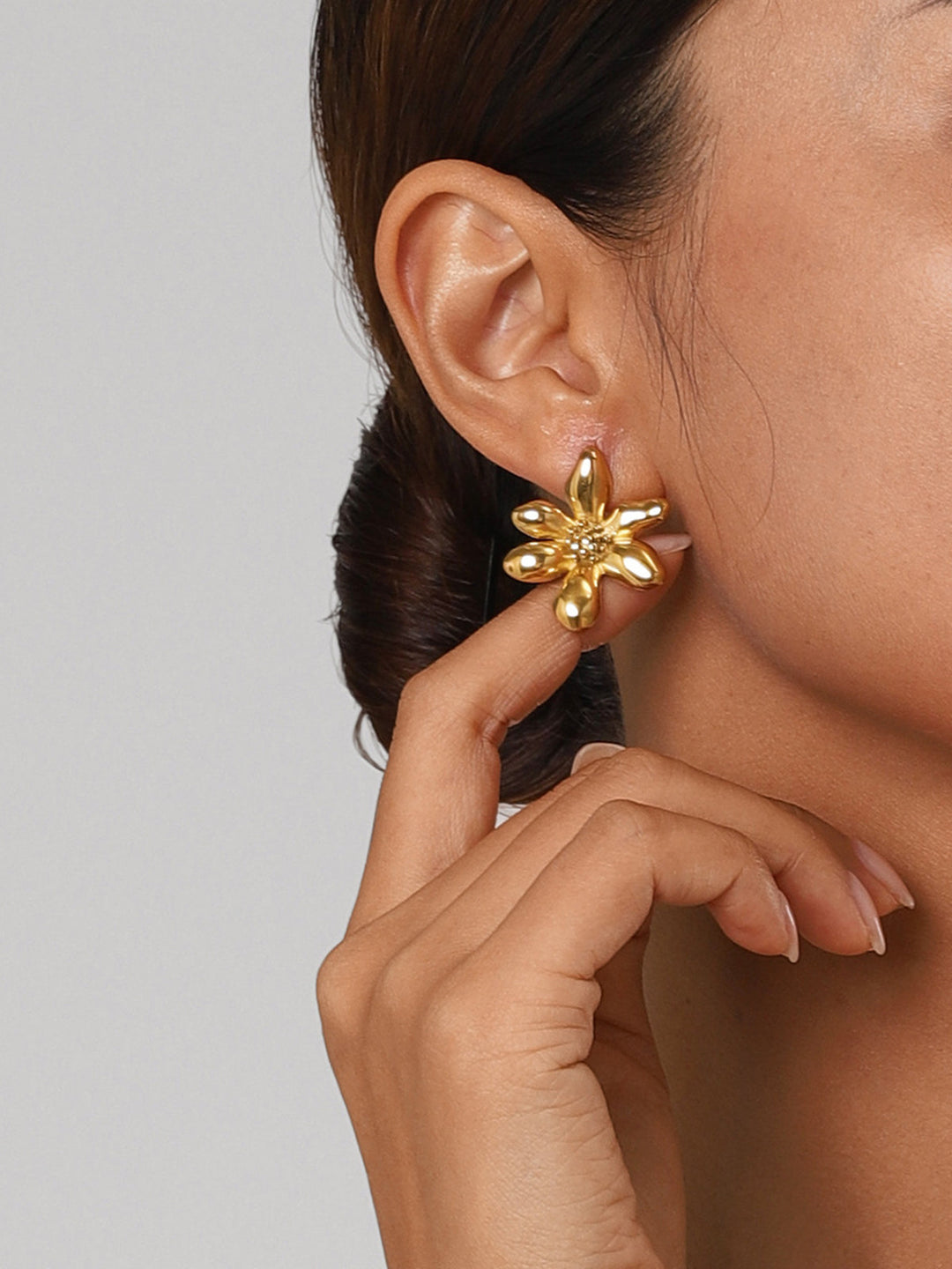 Fashionable titanium steel flower earrings in silver tone, ideal as a women's accessory.