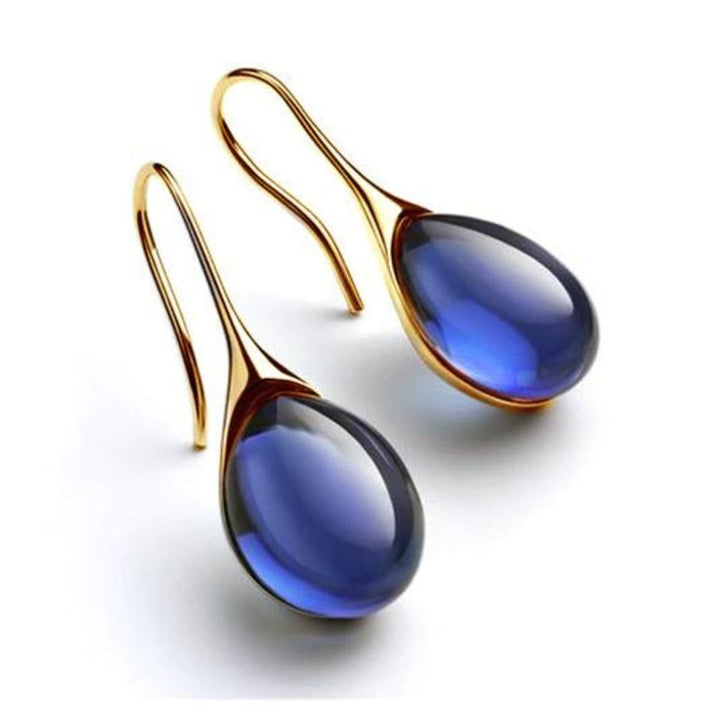 Trendy colorful crystal drop earrings for women. Fashionable dangle earrings with a polished silver tone finish.