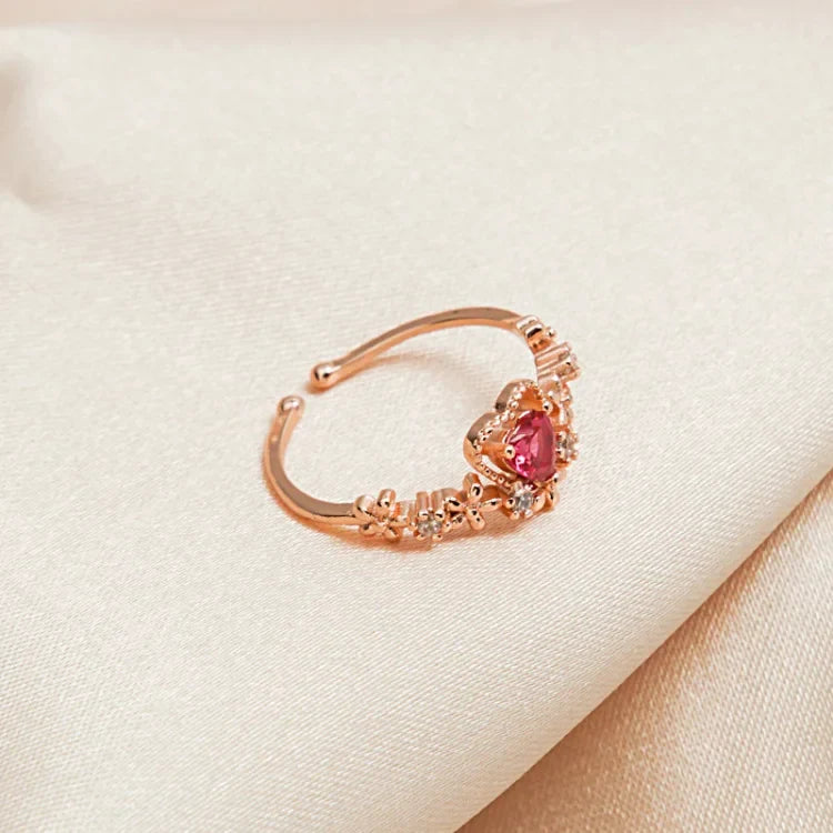 Elegant gold-plated women's ring with a striking red crystal love heart and sparkling AAA Zirconia accents.
