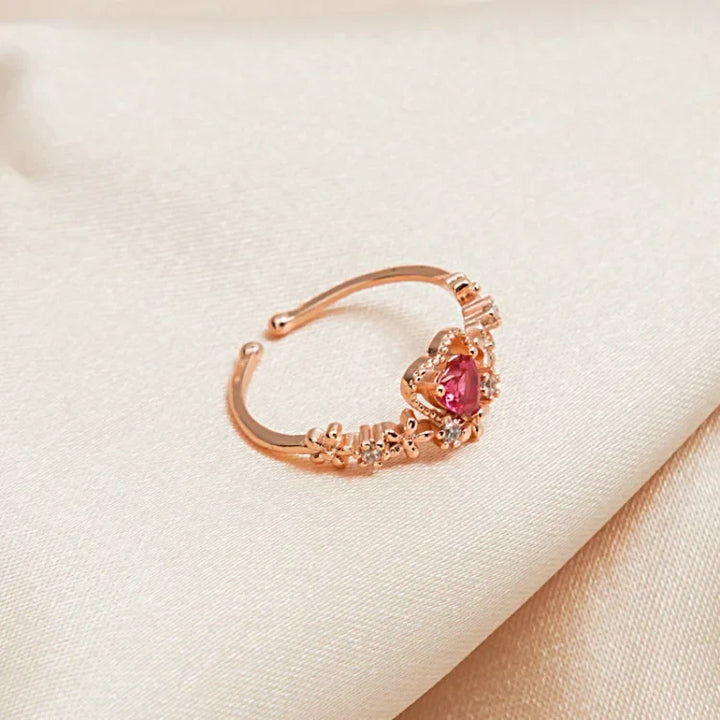 Elegant gold-plated women's ring with a striking red crystal love heart and sparkling AAA Zirconia accents.