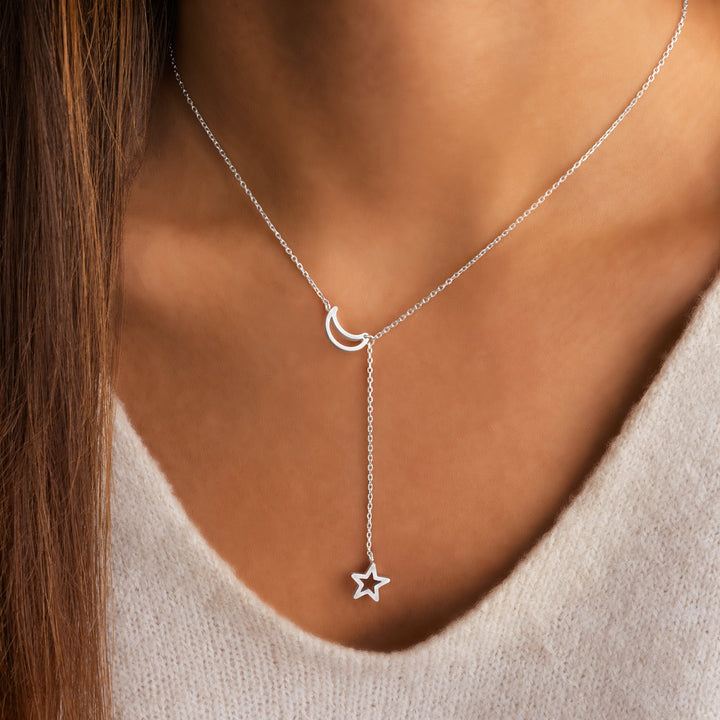 Stylish women's star and moon necklace, gold plated for a celestial look, a beautiful layered fashion accessory.