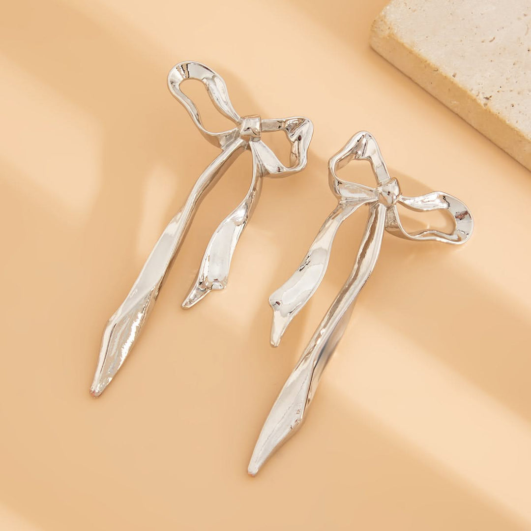 Beautiful gold ribbon bow earrings. Elegant and dainty women's accessory, perfect fashion statement.