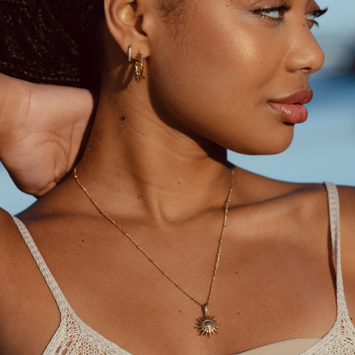 Stylish silver sun pendant necklace, designed for women. A beautiful piece of fashion jewelry, makes a great gift.