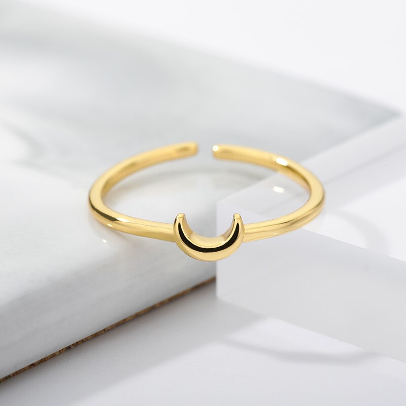 Elegant gold tone minimalist crescent ring for women, an adjustable & stackable fashion accessory.