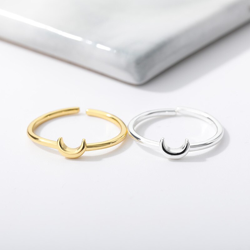 Women's Nova minimalist crescent ring, an elegant adjustable fashion accessory in a modern design.