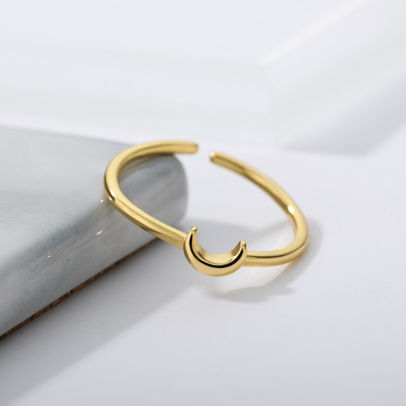 Adjustable minimalist crescent ring for women, perfect for stacking. Elegant gold or silver tone jewelry.